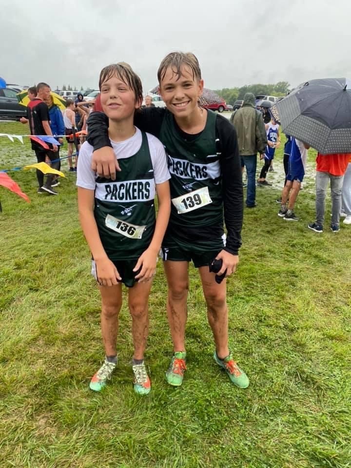 Dawson Nehring and Haakon Seymour run in the rain